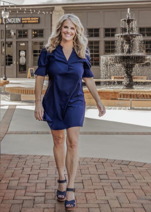 Cumming sleep dentist Doctor Jennifer Sherwood Bragg smiling in blue dress outdoors