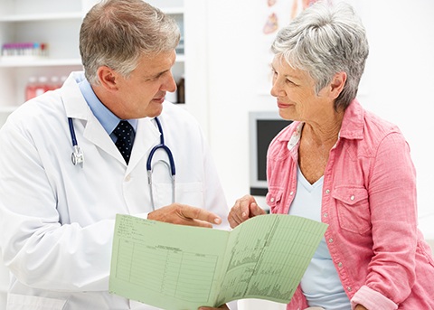 Older woman having serious conversation with doctor