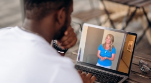Man using laptop for video visit with sleep apnea doctor