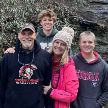 Doctor Bragg with her husband and two sons with rock face in background