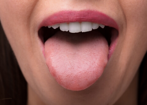 Close up of open mouth with tongue sticking out