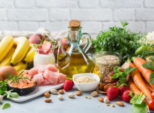 Table covered in fruits vegetables and nuts