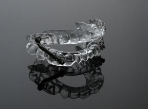 Clear oral appliance resting on tray