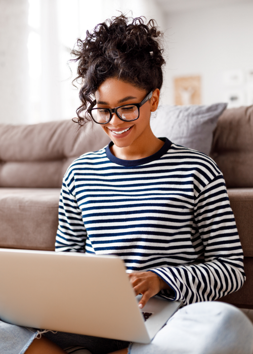 woman smiling while typing on computer