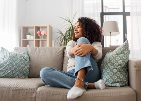 Young woman sitting on her couch