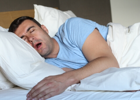 Man sleeping on his side with his mouth open