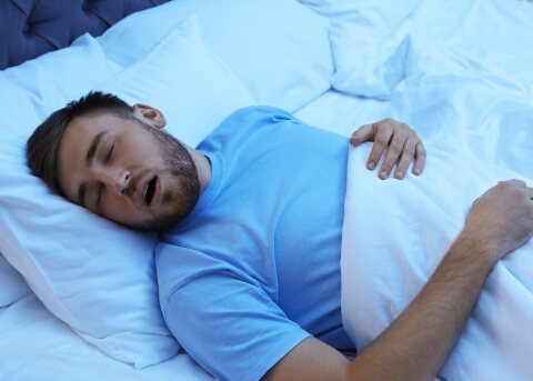 Man sleeping on his back with his mouth open